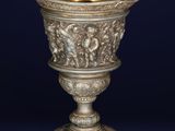 an antique silver cup with a design on the base