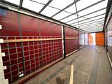 a long hallway in a building with a red wall