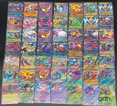 a pile of pokemon cards sitting on top of a table