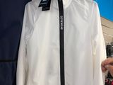 a man that is holding a white shirt and a black tie