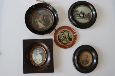 four framed pictures on the wall of a room