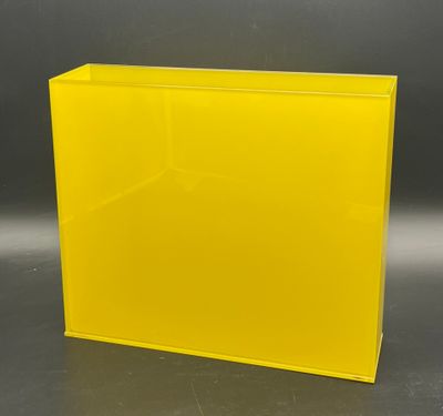 a yellow acrylic display case with a black background