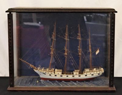 a picture of a model of a ship in a glass case