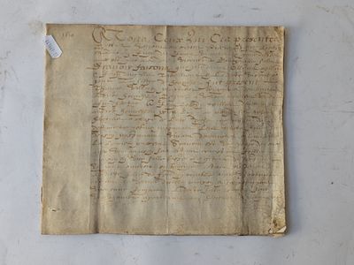 a piece of old paper with writing on it sitting on a table