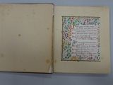 an open book with a picture of flowers and a poem on it