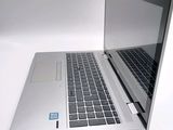 a silver laptop with a blue sticker on the screen
