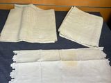 three napkins and two napkins sitting on a table