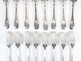 a lot of silver spoons and forks on the table