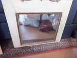 a mirror that is sitting on the floor in front of a couch