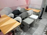 many chairs and tables in a room with a pink wall