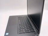 a laptop computer sitting on a table with a keyboard
