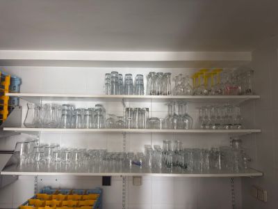many empty glasses on the shelves in the kitchen