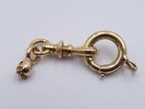 a close up of a gold chain with a skull on it
