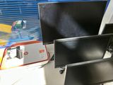 a computer desk with two monitors and a keyboard