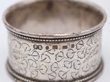 an old silver ring with a floral design on it