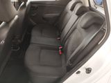 the back seats of a white car with a black seat belt