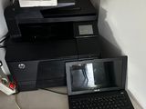 two laptops and a printer sitting on a desk