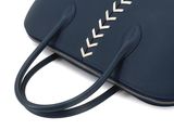 navy blue leather handbag with white stitching on the side