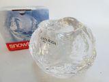 a clear glass vase with a box in the background