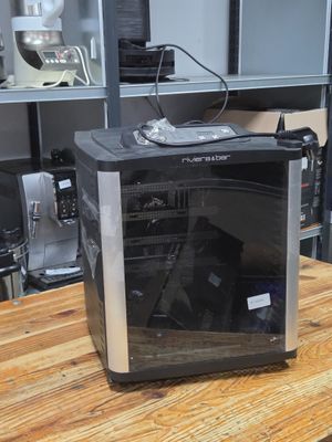 a microwave sitting on a wooden table in a kitchen