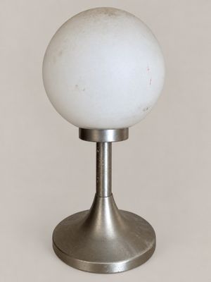 an image of a white glass ball sitting on top of a metal stand