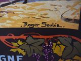 a sign that says roger soubie on the side of a building