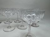 six wine glasses sitting on a table with a white background