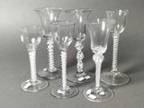 six wine glasses sitting next to each other on a table