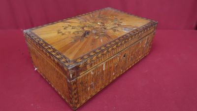 une vieille boîte en bois posée sur un tissu rouge