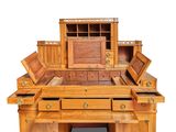 a wooden desk with drawers and a mirror on top of it