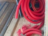 two red hoses sitting next to each other on the floor