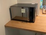 a microwave sitting on top of a counter in a kitchen