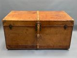 an old wooden trunk sitting on top of a white table
