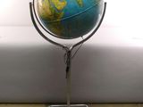 a small blue and yellow globe on a metal stand