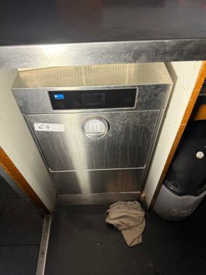 stainless steel dishwasher in a kitchen with a dirty cloth on the floor