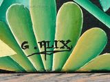 a painting on the wall of a building that has graffiti on it