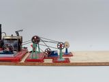 a small model of a steam engine on a wooden board