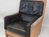 a black leather chair sitting on a white background