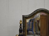 a mirror that is sitting on a table in a room