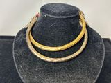 a necklace and bracelet set on a mannequin with a hat