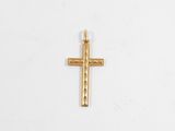 une petite croix dorée sur fond blanc