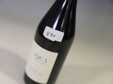 a bottle of wine sitting on a table with a price tag on it