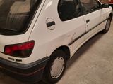 a picture of a white car parked in a garage