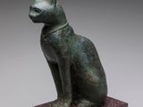 an image of a statue of a cat sitting on top of a block