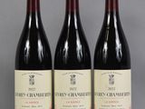trois bouteilles de vin sont alignées sur une table