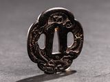 a close up of a small metal object with a dragon on it