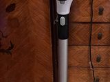 a vacuum that is sitting on the floor in front of a cabinet