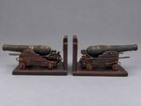 pair of antique cast iron cannon bookends on wooden bases
