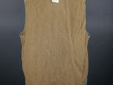 a tan vest on a mannequin stand against a black background