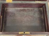 a wooden box with a metal handle on a table